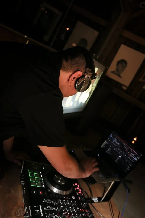 CHIEF at his laptop and controller inside the venue