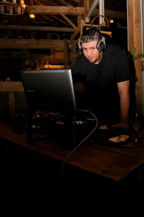 CHIEF at his DJ booth inside a timber-beamed venue